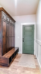 Vertical Hinged panelled wooden fire door with black knob and lock inside a home