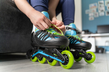 close up on foot of unknown caucasian woman on the floor taking off or putting on the rollerblade...