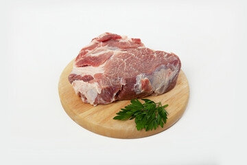 a piece of raw meat pork on a wooden backing
