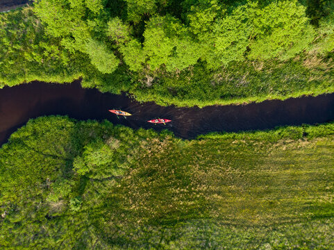Picture of a canoe from a drone on one of the rivers in northern Poland (Kaszuby region near Swornegacie village).