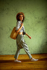 Tourist in a denim jacket and hat with a camera and bag. Happy emotions