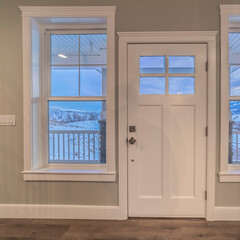 Square White front door flanked by windows interior