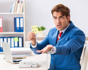 Office prank with kick me message on sticky note