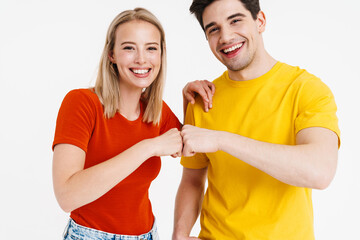 Image of excited nice man and woman laughing and giving fist bump