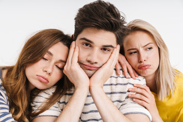 Image of unhappy tired man and women hugging and posing on camera