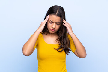 Young Colombian girl over isolated blue background unhappy and frustrated with something. Negative facial expression