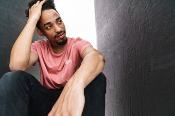 Photo of handsome african american man posing and looking aside