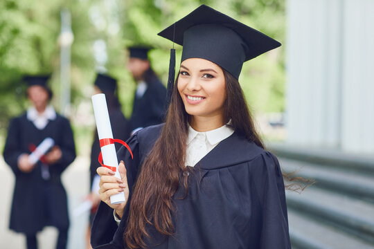 A Young Female Graduate Against The Background Of University Graduates.