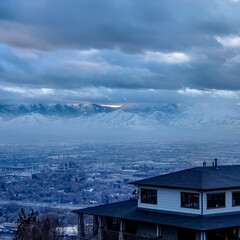 Square Downtown Salt Lake City with snowy mountain and gloomy cloudy sky view in winter