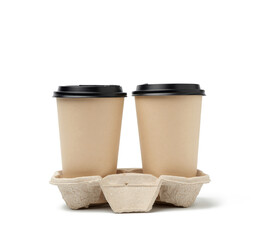 two brown paper disposable cups with a plastic lid stand in the tray