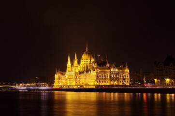 Fototapeta na wymiar Budapest parliament building at night, long exposure. Hungarian Parliament building and Danube River in the Budapest city at night. Neo-gothic architecture, Budapest's tourist attraction