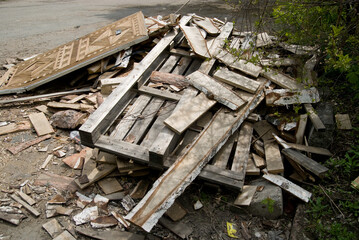 Background of sawn birch boards, trash and an old door piled in a pile