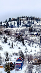 Vertical frame Park City Utah neighborhood in winter with colorful homes on snowy hill top