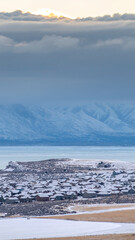 Vertical crop Scenic utah valley landscape with snowy mountain frozen lake and frosted houses