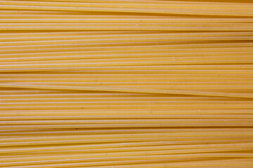 Texture of pasta macaroni from a solid wheat variety light sepia.
