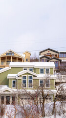 Vertical crop Homes on snowy residential mountain slope in scenic Park City Utah in winter