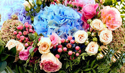Obraz na płótnie Canvas Beautiful bouquet of flowers with blue hydrangea and pink roses. Close-up. Flower delivery on order. Courier delivery service. Floristics