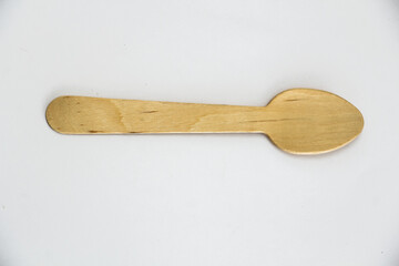Top View of a Wooden Spoon on a white background. Eco-Friendly Cutlery Alternative to Plastic.