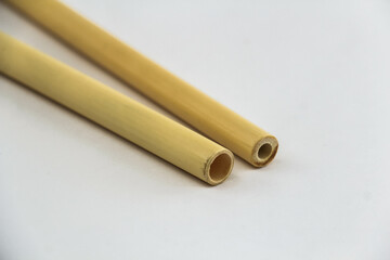 Two Biodegradable Bamboo Straws on a white background. Environmentally Friendly Alternative to Plastic. Close Up.