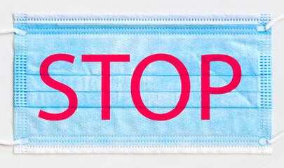 Stop the virus and epidemic diseases. Blue hygienic mask with the word stop written on it.