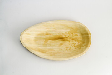 Oval Areca Leaf Tray, eco-friendly disposable cutlery. Top view on a white background.