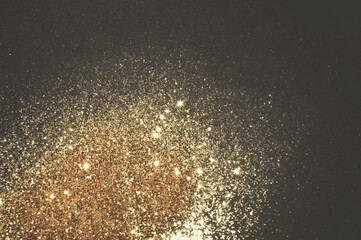 Gold glitter on black background for your design