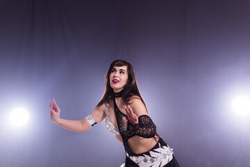 Portrait of a woman in oriental costume performing belly dance. Tribal fusion dance concept.