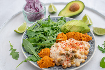 Vegan lunch bowl with quinoa, hummus, chickpeas, avocado, 