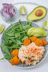 Vegan lunch bowl with quinoa, hummus, chickpeas, avocado, 