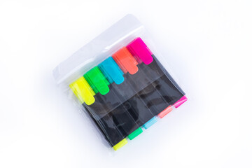 Five Colorful Markers in a Transparent Plastic Packet. Top View. Highlighters on a white isolated background. Children and Artist Pens. Office Highlighters. Pack of Yellow, Green, Blue, Orange & Pink.