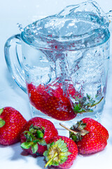 Strawberries in a mug with water with bubbles close-up