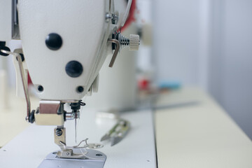 Close-up of sewing machine foot. Seamstress equipment