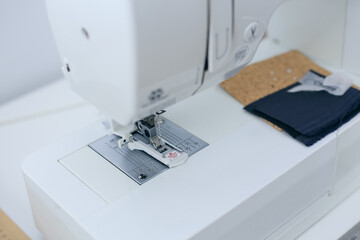 Close-up of sewing machine foot with buttonhole. Special nozzle for seamstress equipment