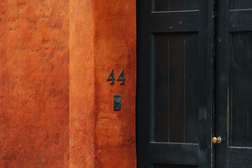 old wooden door with earth wall