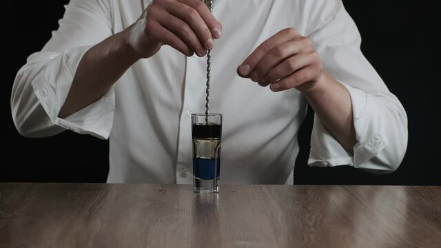 Preparing of Lexus Cocktail. Close up pouring coffee liquor into a glass