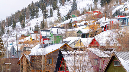 Panorama Residential neighborhood on hill slope with fresh snow and trees in winter
