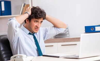 Overloaded busy employee with too much work and paperwork