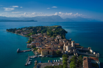 Obraz premium Castle Rocca Scaligera in Sirmione, Garda Lake. View by Drone. Panoramic aerial view of the historic city of Sirmione. Alps of Lake Garda
