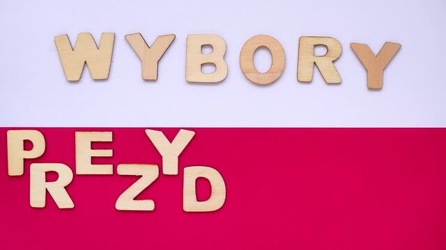 PRESIDENTAL ELECTIONS - polish-wybory prezydenckie - word made from wooden letters. Selective focus. Elections in Poland theme. Letters on the background with white and red flag of Poland