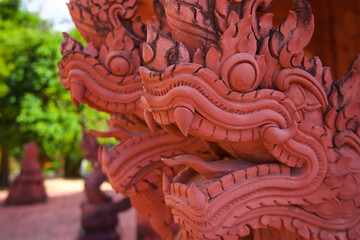 snakes in Buddhism are sacred animals, their other name is naga, reptiles guard the entrance to the temple, made of concrete and paints