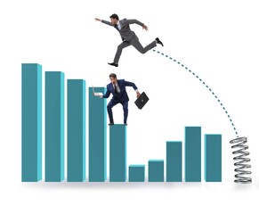 Businessman outperforming his competition jumping over