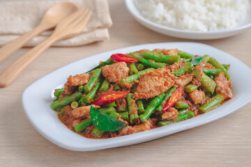 Stir fried pork with yard long bean and red curry paste served with rice, Thai food