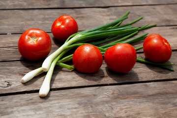 Healthy food Fresh farm vegetables tomatoes, cucumbers, salad lola rossaa and lola bianca, green onions, cabbage. Non-GMO Organic Vegetables, 100% Vegan Vegetarian Slimming Diet Wooden Background
