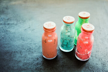 Whole and cracked glass bottles with rubber corks and dried old artistic paint