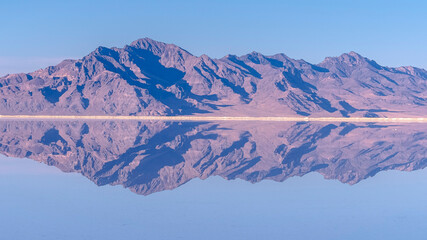 Panorama Mountains reflected as mirror image in still water