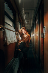 Fototapeta na wymiar Girl travels in a train carriage