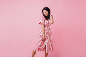 Romantic slim woman with brown hair dancing with inspired smile. Pretty caucasian girl posing in...