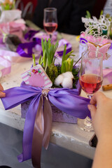 woman tying a bow on a square planter with hyacinths