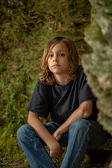 Boy Sitting on A Rock