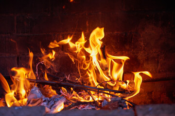 Obraz premium Fire in the hearth burning brightly. Traditional farmhouse fireplace. Natural photo story. Perfect illustration hot for your page magazine
